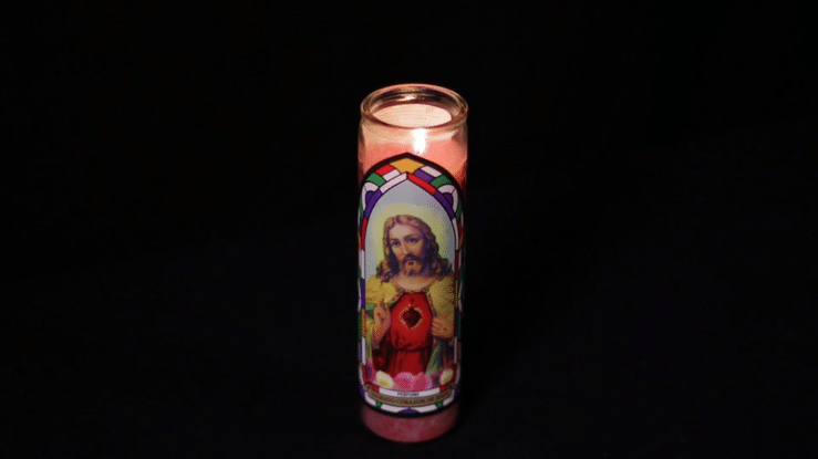 Sacred Heart of Jesus Candle burning